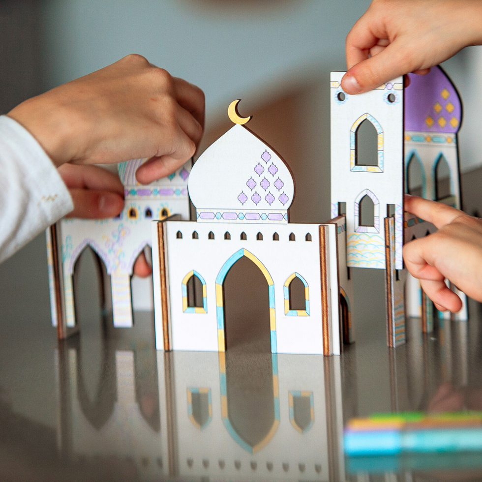 Kids' hands assembling the Wooden Masjid Craft Kit